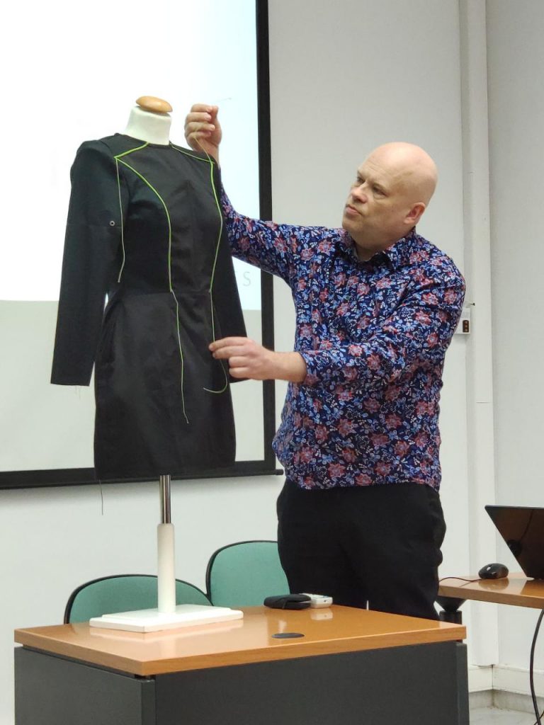 A Swedish project member demonstrating a self-created black dress prototype